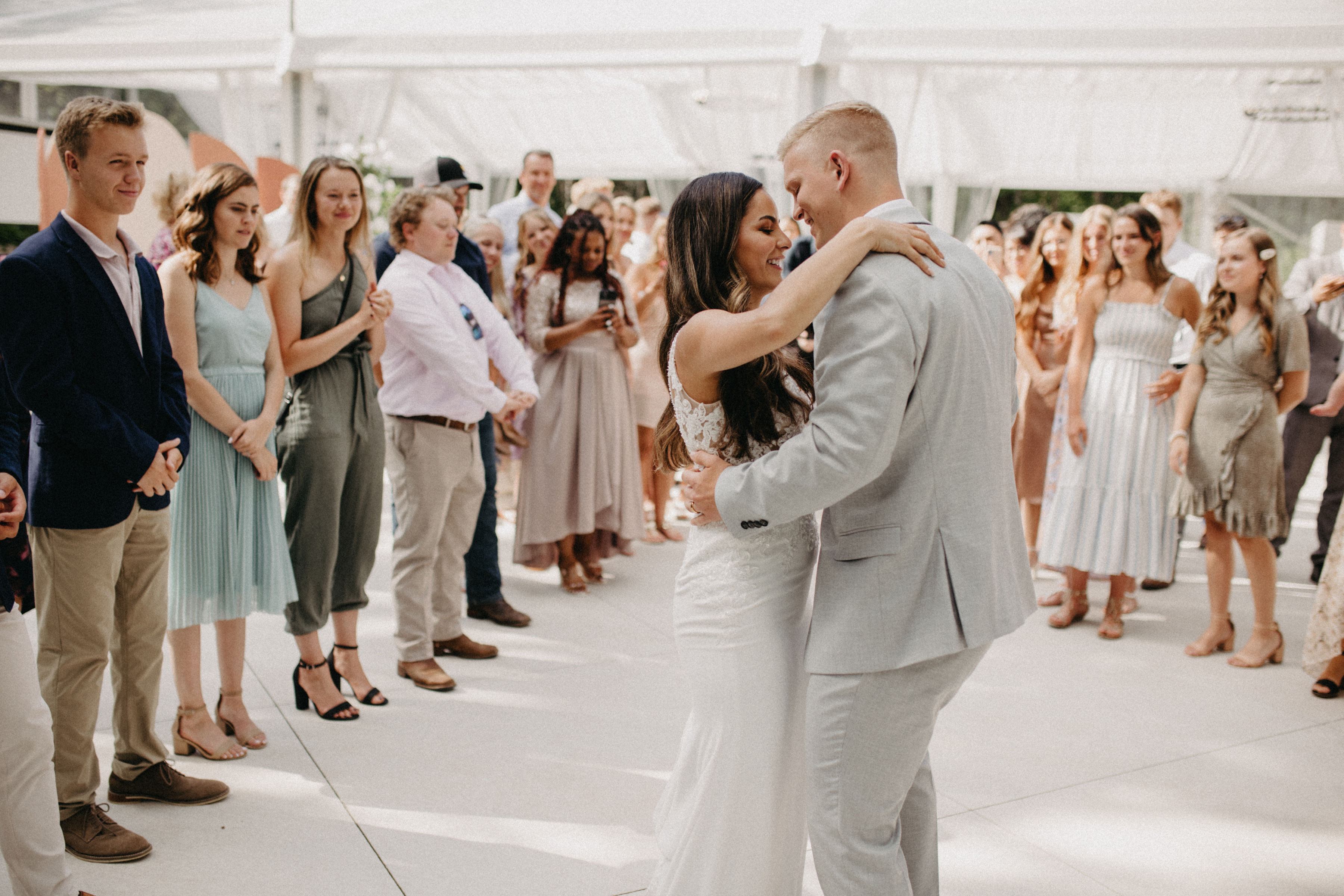 A couple's first dance surrounded by guests at a Prairie wedding, captured by Roam Content Co.